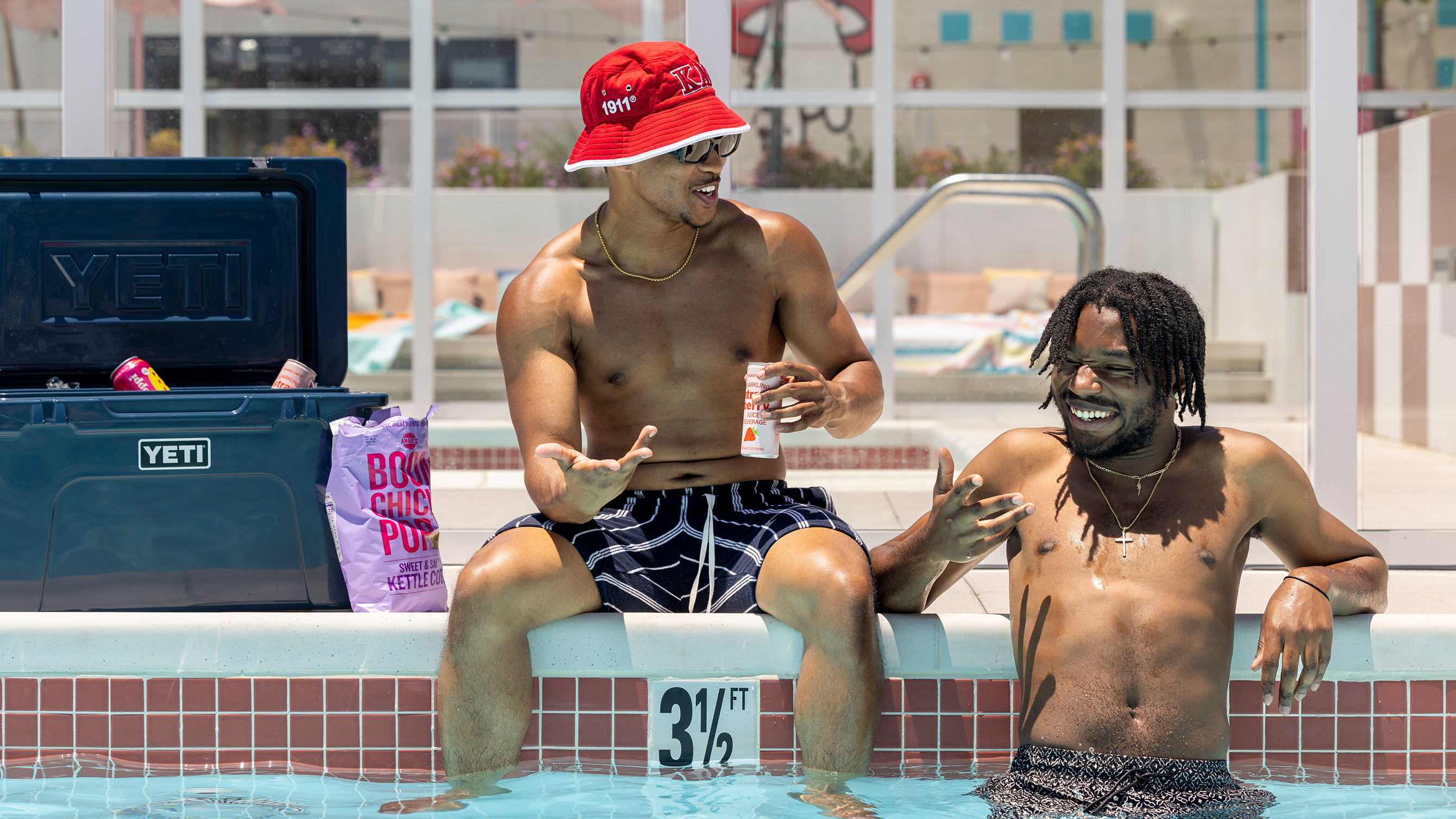 Friends talking while inside a swimming pool