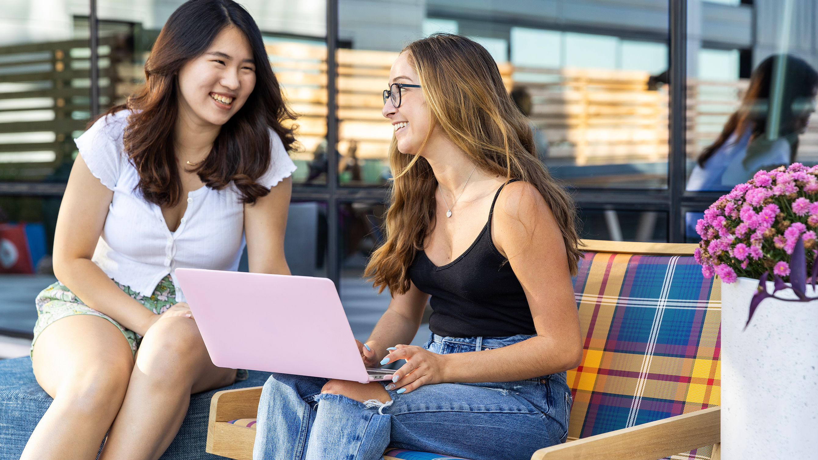 Two people using a laptop